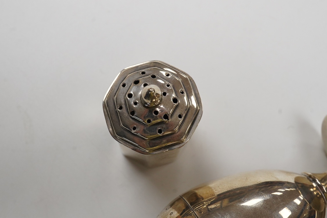 A George III provincial silver egg shaped pedestal pepperette, by Christian Ker Reid, Newcastle, circa, 1810, height 89mm, together with a pair of late Victorian octagonal pepperettes.